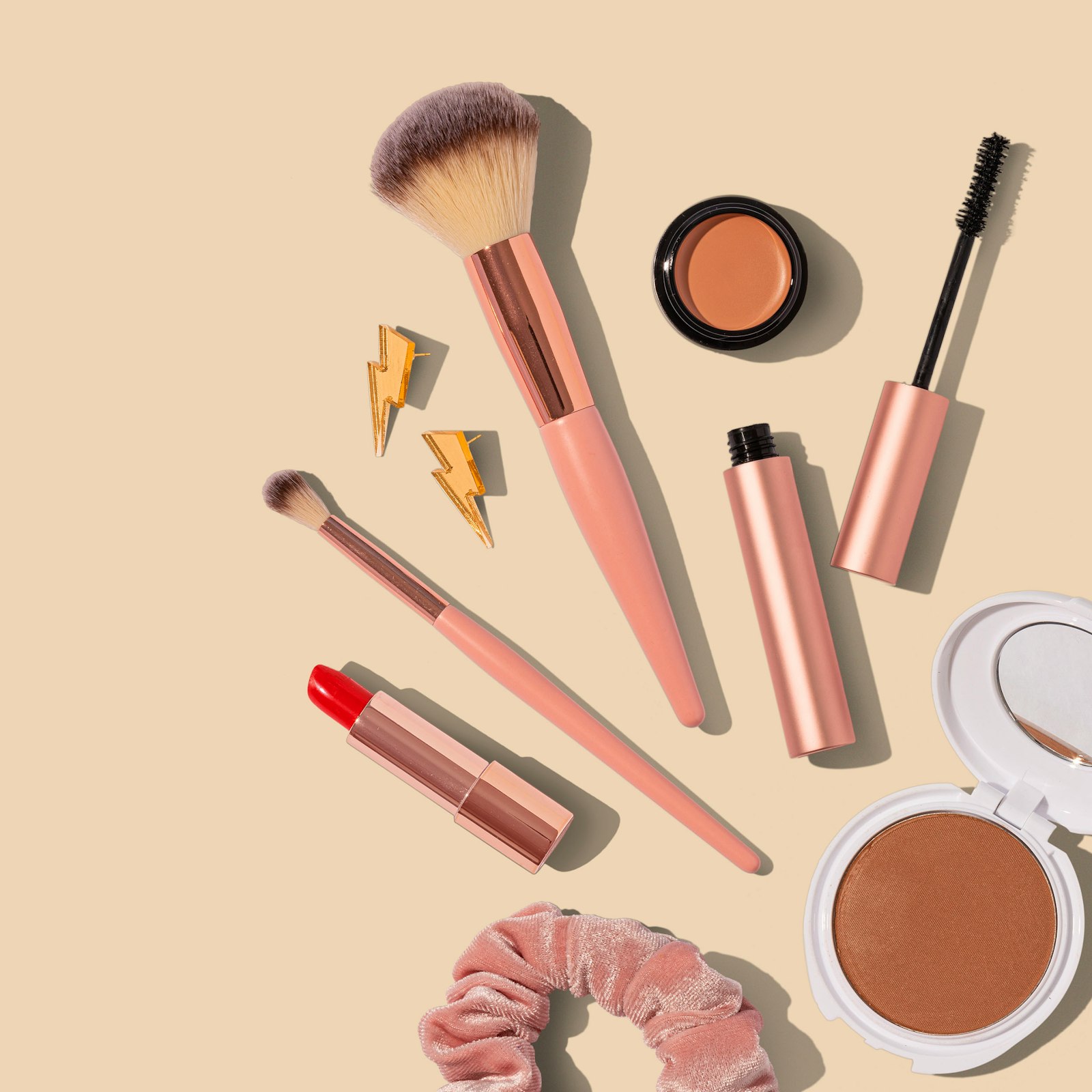 Cosmetics packaging laid flat on a neutral background